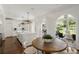 Bright and airy kitchen with white cabinetry, an island, and view of the backyard and pool at 315 Peachtree Battle Nw Ave, Atlanta, GA 30305