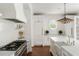 Well-appointed kitchen featuring white cabinetry, stainless steel appliances, and hardwood flooring for a modern touch at 315 Peachtree Battle Nw Ave, Atlanta, GA 30305