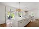 Open concept kitchen with marble island and countertops, hardwood floors, and view to outside living area at 315 Peachtree Battle Nw Ave, Atlanta, GA 30305