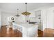 Spacious white kitchen with large island, marble countertops, stainless steel stools, and hardwood floors at 315 Peachtree Battle Nw Ave, Atlanta, GA 30305