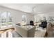 Open-concept living room featuring hardwood floors, white trim, large windows, and a stylish seating arrangement at 315 Peachtree Battle Nw Ave, Atlanta, GA 30305