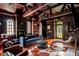 Luxurious living room with wood paneled walls, hardwood floors, built in bookshelves, and natural light at 315 Peachtree Battle Nw Ave, Atlanta, GA 30305