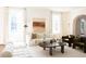Elegant living room with white sofas, a wooden coffee table, and large windows for natural light at 315 Peachtree Battle Nw Ave, Atlanta, GA 30305