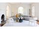 Elegant living room featuring a fireplace, chandelier, hardwood floors, and neutral decor at 315 Peachtree Battle Nw Ave, Atlanta, GA 30305