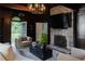 Charming living room features stone fireplace, dark wood accents, and opens to outdoor garden at 315 Peachtree Battle Nw Ave, Atlanta, GA 30305