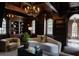Elegant living room showcasing dark wood paneling, built-in shelving, arched windows and sophisticated décor at 315 Peachtree Battle Nw Ave, Atlanta, GA 30305