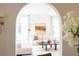 Bright living room featuring white sofas, a wooden coffee table, and an archway entrance at 315 Peachtree Battle Nw Ave, Atlanta, GA 30305
