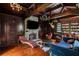 Living room with stone fireplace, wood paneled walls, hardwood floors and coffered ceilings at 315 Peachtree Battle Nw Ave, Atlanta, GA 30305