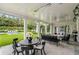 Covered patio with outdoor dining, seating around a fire pit, and view to the pool and lawn at 315 Peachtree Battle Nw Ave, Atlanta, GA 30305