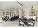 Covered patio with outdoor seating and dining, ceiling fan, and view into the kitchen and yard at 315 Peachtree Battle Nw Ave, Atlanta, GA 30305