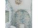 Stylish powder room with intricate blue wallpaper and modern chandelier lighting at 315 Peachtree Battle Nw Ave, Atlanta, GA 30305