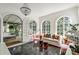 Sunroom with black tile flooring, chandelier, and large windows offering scenic views of outdoors at 315 Peachtree Battle Nw Ave, Atlanta, GA 30305