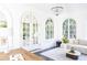 Bright sunroom with arched windows, chandelier, and stylish decor creating a cozy atmosphere at 315 Peachtree Battle Nw Ave, Atlanta, GA 30305
