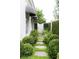 Stone walkway leading to a gated entrance, bordered by lush greenery and manicured bushes at 315 Peachtree Battle Nw Ave, Atlanta, GA 30305