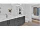 Contemporary bathroom with a double sink vanity, black fixtures and bedroom access at 112 Rogers Ne St # 207, Atlanta, GA 30317