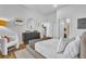 A bright bedroom features hardwood floors and neutral decor with ensuite access at 112 Rogers Ne St # 207, Atlanta, GA 30317