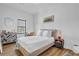 A bedroom featuring a full bed, a dresser and wood floors with natural lighting at 112 Rogers Ne St # 207, Atlanta, GA 30317