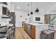 Modern kitchen with central island and open layout flowing into the living area at 112 Rogers Ne St # 207, Atlanta, GA 30317