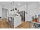 Modern kitchen with stainless steel appliances, pendant lighting, and sleek white countertops at 112 Rogers Ne St # 207, Atlanta, GA 30317