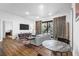 Bright living room with hardwood floors, a balcony, and modern furnishings at 112 Rogers Ne St # 207, Atlanta, GA 30317