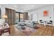 Open living room with a large sectional sofa and access to a balcony with a view at 112 Rogers Ne St # 207, Atlanta, GA 30317