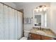 Bathroom with a neutral-patterned shower curtain and stylish fixtures, providing a comfortable and functional space at 1861 8Th St, Atlanta, GA 30341