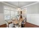 Dining room with wood table and six chairs beneath decorative chandelier at 1861 8Th St, Atlanta, GA 30341