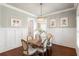 Dining room with wood table and six chairs beneath decorative chandelier at 1861 8Th St, Atlanta, GA 30341