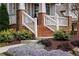 Charming brick stairs leading to a cozy covered porch surrounded by lush landscaping at 1861 8Th St, Atlanta, GA 30341