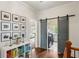 Hallway featuring hardwood floors, barn door leading to laundry, and wall art gallery at 1861 8Th St, Atlanta, GA 30341