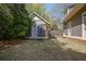 Well-maintained backyard with lush grass, mature trees, and a charming separate structure at 645 Iroquois Ne Dr, Marietta, GA 30060