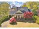 Charming home with beautiful landscaping, covered porch and driveway, and distinctive architectural details at 645 Iroquois Ne Dr, Marietta, GA 30060