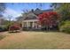 Inviting two-story home with classic design, well-maintained lawn, and a beautiful maple tree at 645 Iroquois Ne Dr, Marietta, GA 30060