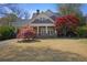 Charming home with a welcoming front porch, lush lawn, and attractive landscaping at 645 Iroquois Ne Dr, Marietta, GA 30060