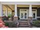 Close up of the home's porch, with stone accents, seating, and a brick pathway at 645 Iroquois Ne Dr, Marietta, GA 30060