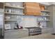 Close-up of kitchen featuring open shelving, modern appliances and a wood range hood at 645 Iroquois Ne Dr, Marietta, GA 30060