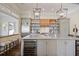 Modern kitchen featuring a large island, wine cooler, open shelving, and designer lighting at 645 Iroquois Ne Dr, Marietta, GA 30060