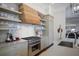 Kitchen featuring open shelving, modern appliances and a wood range hood at 645 Iroquois Ne Dr, Marietta, GA 30060
