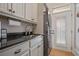 Efficient laundry room featuring granite countertops and stainless-steel appliances at 645 Iroquois Ne Dr, Marietta, GA 30060
