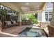 Covered patio featuring a built-in grill, hot tub, and porch swing for outdoor enjoyment at 645 Iroquois Ne Dr, Marietta, GA 30060