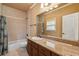 Well-lit bathroom featuring tile surround with a shower-tub combo at 6935 Wakehurst Pl, Cumming, GA 30040