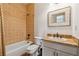 Cozy bathroom featuring a tiled shower-tub combo and granite countertop at 6935 Wakehurst Pl, Cumming, GA 30040