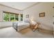 Bright bedroom with large windows offering scenic views, simple decor, and cozy carpet at 6935 Wakehurst Pl, Cumming, GA 30040