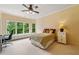 Relaxing bedroom with built-in window seating, desk area, and bright natural light at 6935 Wakehurst Pl, Cumming, GA 30040
