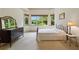 Bright bedroom features a large window with a scenic view and neutral color palette at 6935 Wakehurst Pl, Cumming, GA 30040
