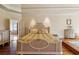 Elegant bedroom featuring hardwood floors and a view to the bathroom with soaking tub and glass shower stall at 6935 Wakehurst Pl, Cumming, GA 30040