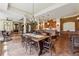 Open dining area with brick accents, chandelier lighting, and access to the living room at 6935 Wakehurst Pl, Cumming, GA 30040