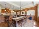 Elegant dining area with chandelier, brick accents, and access to kitchen at 6935 Wakehurst Pl, Cumming, GA 30040