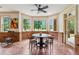 Cozy dining area featuring brick accents, large windows, and outdoor views at 6935 Wakehurst Pl, Cumming, GA 30040
