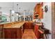 Well-equipped kitchen with wooden cabinets, granite countertops, and brick accents at 6935 Wakehurst Pl, Cumming, GA 30040